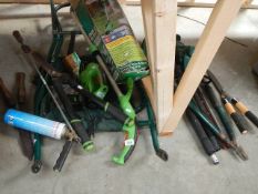 A quantity of electric garden tools and a flat pack wheel barrow.