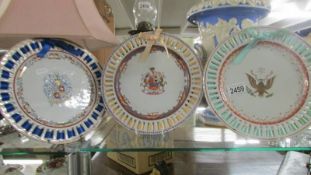 Three armorial ribbon plates.