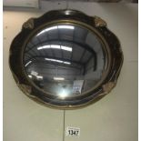 A gilt & walnut effect port hole mirror with concave glass.