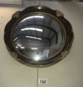 A gilt & walnut effect port hole mirror with concave glass.