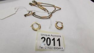 A pair of 9ct gold hoop earrings and a yellow metal chain.