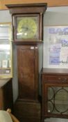 An oak cased 8 day long case clock with brass dial.