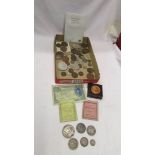 A mixed lot of coins including 63 grams of silver coins.