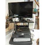 A television on stand with video and DVD player, in working order.