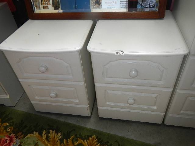 A pair of white bedsides.