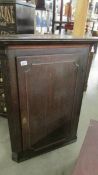 An oak corner cupboard.