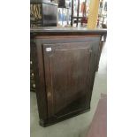 An oak corner cupboard.