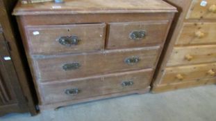 A 2 over 2 pine chest of drawers.