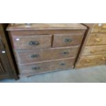 A 2 over 2 pine chest of drawers.