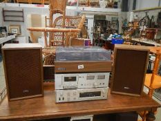 An Onkyo record deck, speakers, amplifier and a Rotek cassette.