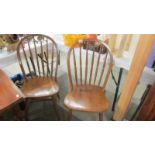 A pair of Ercol style kitchen chairs.