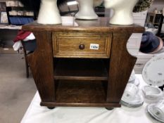 An oak coffee table magazine rack with drawer