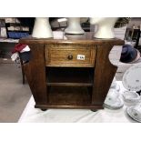 An oak coffee table magazine rack with drawer