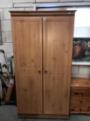 A pine effect 2 door wardrobe,