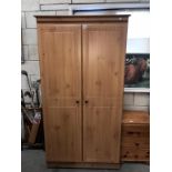 A pine effect 2 door wardrobe,