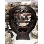 A dark wood stained barrel shaped bottle rack (height 69cm, width 47cm,