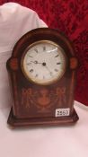 A mahogany inlaid mantel clock.