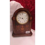 A mahogany inlaid mantel clock.