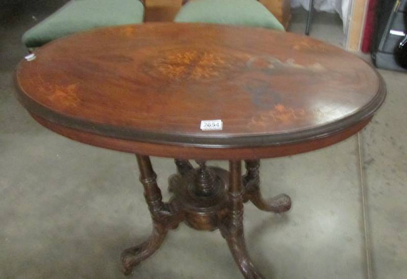 An oval mahogany inlaid dining table (top needs re-polishing).