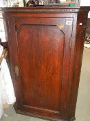 A mahogany corner cupboard.