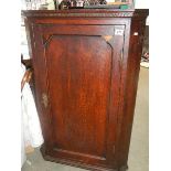 A mahogany corner cupboard.