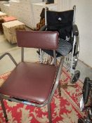 A wheel chair and a commode.