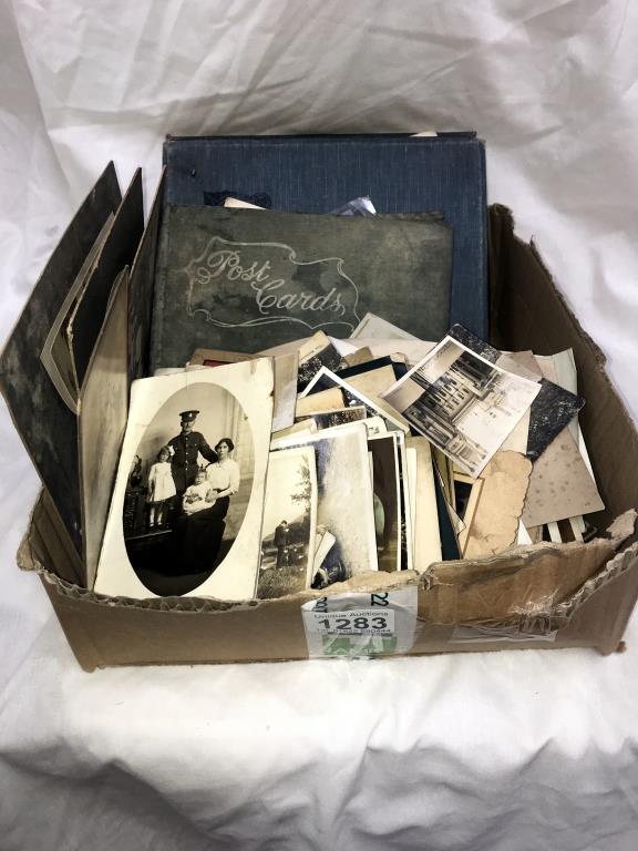 A box of old sepia photographs including albums & postcards