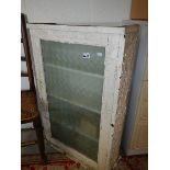 A glazed door cabinet.