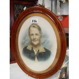 A 1920's portrait of an old lady in oval frame.