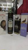 Four bottles of whisky - Three The Famous Grouse and one The Black Grouse blended.