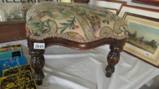 A mahogany foot stool with reeded legs.