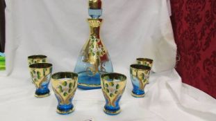 A pretty overlaid glass liquor decanter with six matching glasses.