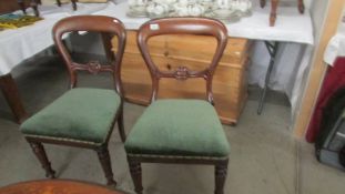 A pair of Victorian mahogany dining chairs.