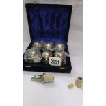 A cased set of 6 silver plate goblets and a wine bottle stopper.