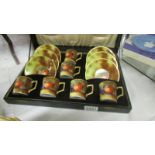 A cased hand painted Japanese coffee set, signed.