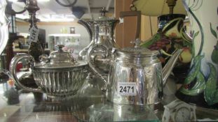 Two silver plate teapots and coffee pot.