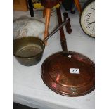 A Victorian copper warming pan and a brass saucepan.