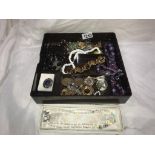 A box of costume jewellery including brooches & necklaces etc.