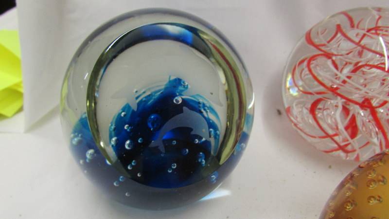 Five glass paperweights and a perspex Royal Mint paperweight inset with £1 coin. - Image 5 of 7