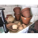 A selection of terracotta plant pots including lions feet some a/f