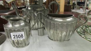 A three piece silver plate tea set.