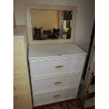 A white three drawer chest.