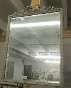 A framed bevel edged mirror.