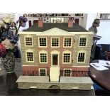 A large doll's house modelled on a George III circa 1790 mansion, electric fittings.
