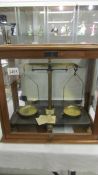 A cased set of apothecary scales.