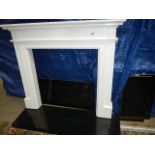 A white fire surround with black hearth.