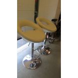 A pair of chrome bar stools.