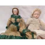 A Victorian wooden peg doll with porcelain head and a porcelain baby doll.