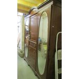 A mahogany inlaid combination wardrobe with mirror doors.