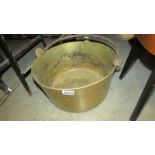 A large heavy brass jam pan.